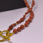 Roku darināta kaklarota „Zelta ausma“